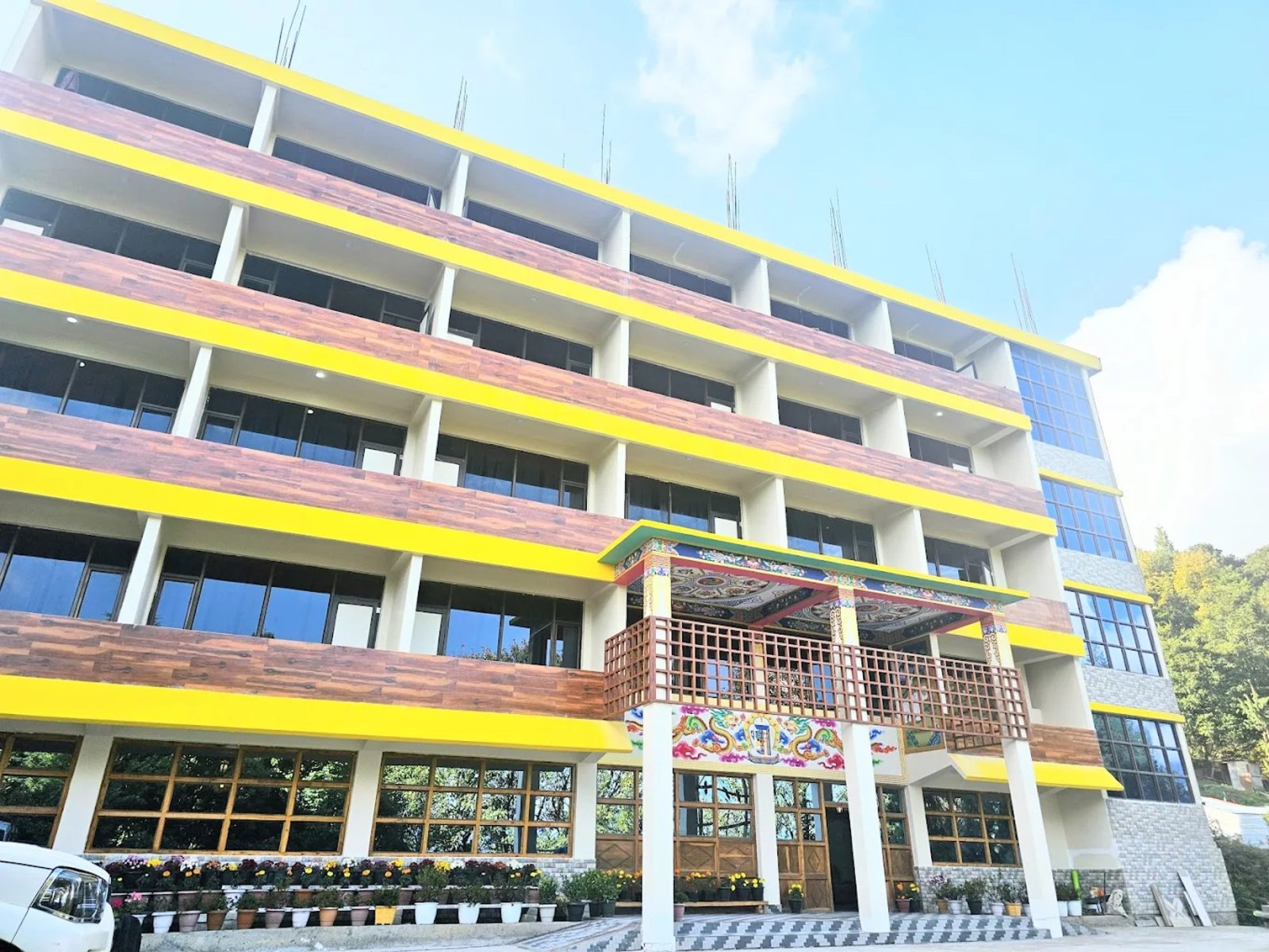 The newly-finished wing of Hotel Taktsang &mdash; warm wood and painted Monpa motifs
