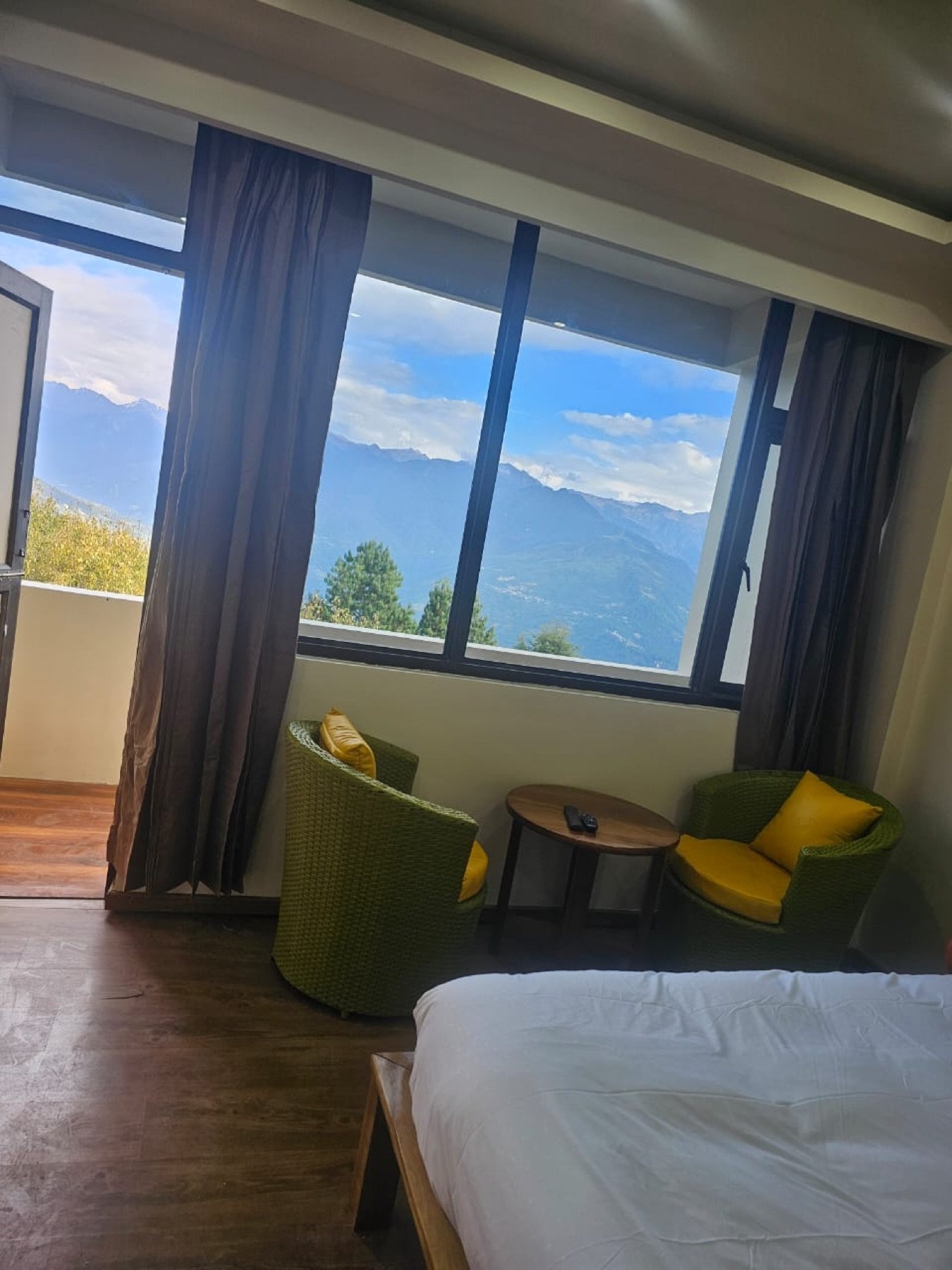 Two chairs by the window at Hotel Taktsang, looking out at the Tawang peaks